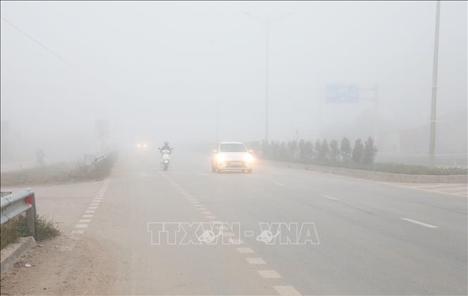 Hiện tượng sương mù dày đặc vào sáng 9/1 trên Quốc lộ 4B, đoạn qua địa bàn phường Kỳ Lừa, tỉnh Lạng Sơn khiến phương tiện tham gia giao thông phải bật đèn cảnh báo tránh va chạm. Ảnh: Văn Đạt - TTXVN