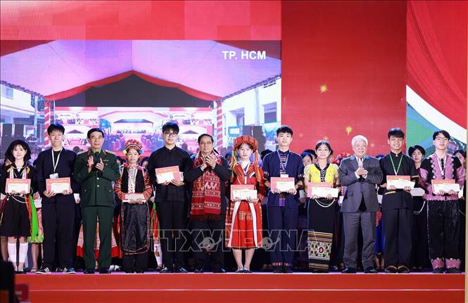 Thủ tướng Phạm Minh Chính tặng quà cho học sinh xuất sắc tiêu biểu, đại diện các dân tộc. Ảnh: Dương Giang-TTXVN 
