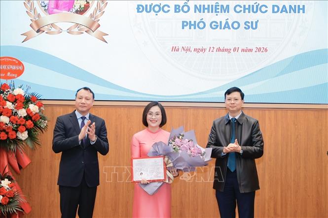 Lãnh đạo trường Đại học Sư phạm Hà Nội trao Quyết định và tặng hoa cho các tân Phó Giáo sư. Ảnh: Minh Quyết - TTXVN