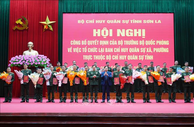 Lãnh đạo Quân khu 2 và tỉnh Sơn La trao quyết định, tặng hoa chúc mừng các Chỉ huy trưởng Ban Chỉ huy Quân sự xã, phường. Ảnh: Nguyễn Cường - TTXVN