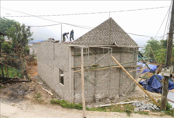 Những ngôi nhà được xây cho các gia đình bị ảnh hưởng của lũ ống, lũ quét trên các diện tích đất xen kẽ trong các bản làng ở xã Nhôn Mai (Nghệ An) đang vào giai đoạn cất nóc, dần hoàn thiện. Ảnh: Xuân Tiến - TTXVN 