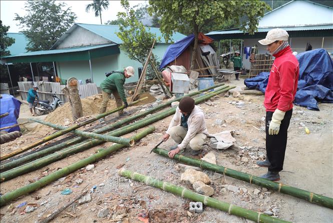 Người dân bản Na Lợt (xã Nhôn Mai, tỉnh Nghệ An) tham gia đóng góp ngày công để đẩy nhanh tiến độ làm nhà ở mới cho các gia đình bị ảnh hưởng của lũ ống, lũ quét. Ảnh: Xuân Tiến - TTXVN 