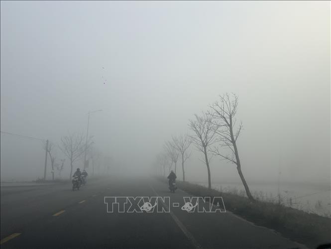 Do sương mù dày đặc nên tầm nhìn xa giảm xuống dưới 100m, có những nơi tầm nhìn chỉ còn 20 đến 30m, gây khó khăn cho việc tham gia giao thông. Ảnh: Hoàng Ngà - TTXVN