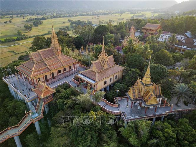 Chùa Tà Pạ (hay còn gọi là Chùa Núi - Chưn-Num) ở xã Tri Tôn là ngôi chùa Khmer nổi tiếng với kiến trúc độc đáo trên đỉnh núi Tà Pạ, trông như lơ lửng giữa trời, nổi bật với màu sắc rực rỡ, mái cong vút và tháp chuông cao, không gian yên bình giữa núi rừng hoang sơ cùng cánh đồng lúa và hồ nước xanh mát bao quanh, là điểm đến tâm linh và check-in hấp dẫn. Ảnh: Khánh Hoà – TTXVN 