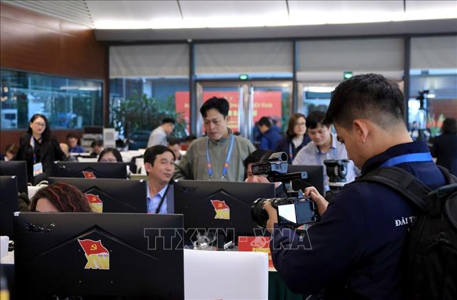 Phóng viên, biên tập viên tác nghiệp tại Trung tâm báo chí của Đại hội. Ảnh: TTXVN