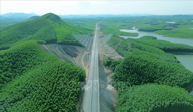 Nghị quyết Đại hội XIII của Đảng xác định ba đột phá chiến lược, gồm hoàn thiện đồng bộ thể chế, phát triển nguồn nhân lực và xây dựng kết cấu hạ tầng đồng bộ, hiện đại. Trong đó, đột phá về kết cấu hạ tầng đồng bộ, hiện đại được xác định là nhiệm vụ trọng tâm nhằm phát triển kinh tế-xã hội đất nước nhanh và bền vững. Trong ảnh: Cao tốc Vạn Ninh - Cam Lộ xuyên qua cánh rừng. Ảnh: Quốc Khánh - TTXVN