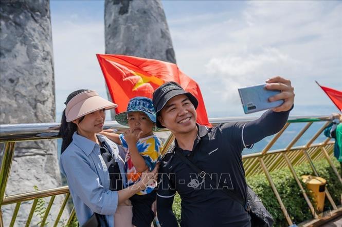 Nhằm tạo ấn tượng và cảm xúc đặc biệt cho khách du lịch nhân dịp Quốc khánh 2/9, Khu du lịch Sun World Ba Na Hills (Đà Nẵng) trang hoàng rực rỡ bằng những lá cờ Tổ quốc và tạo hình nhiều món ăn, vẽ nón mang dáng hình màu cờ Quốc kỳ Việt Nam đã thu hút rất đông du khách trong và ngoài nước đến tham quan, chụp ảnh. Ảnh: TTXVN phát