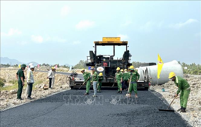 Việc thảm nhựa tuyến đường dẫn góp phần kết nối Quốc lộ 91 với tuyến cao tốc. Ảnh: Thanh Sang-TTXVN
