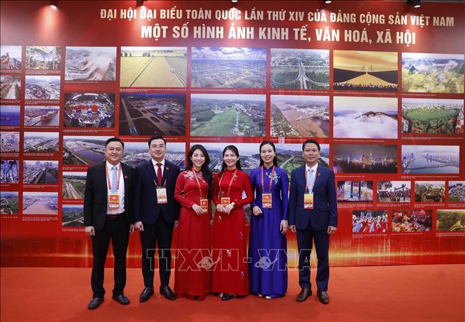 Các đại biểu chụp ảnh lưu niệm ở khu trưng bày ảnh của Thông tấn xã Việt Nam tại phiên khai mạc Đại hội XIV của Đảng. Ảnh: TTXVN