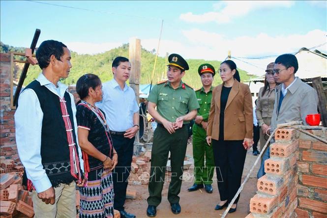 Chủ tịch UBND xã A Vương Briu Quân (ngoài cùng bên phải) cùng Đoàn công tác UBND thành phố Đà Nẵng thăm hỏi bà con bị thiệt hại nhà cửa do mưa lũ. Ảnh: TTXVN phát