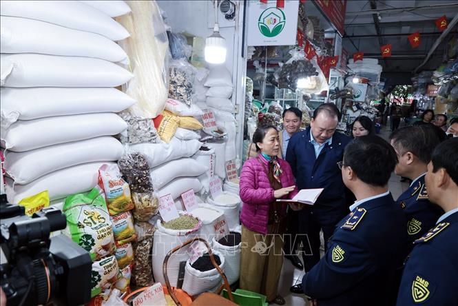 Đoàn kiểm tra một quầy kinh doanh lương thực tại chợ Hà Đông, Hà Nội. Ảnh: Trần Việt - TTXVN