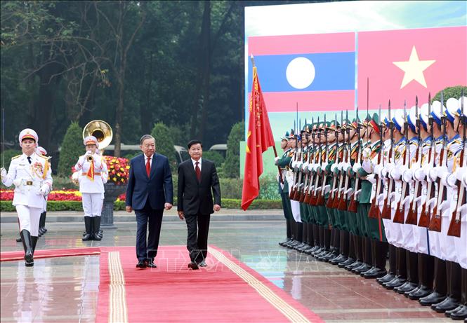General Secretary of the Communist Party of Vietnam (CPV) Central Committee To Lam and General Secretary of the Lao People’s Revolutionary Party (LPRP) Central Committee and President of Laos Thongloun Sisoulith review the guard of honour of the Vietnam People’s Army. VNA Photo