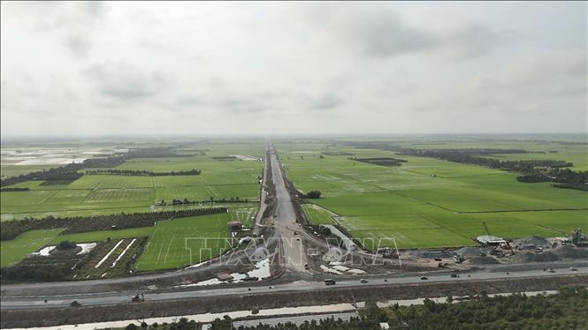 Điểm đầu cao tốc và hai đường dẫn tuyến cao tốc Châu Đốc – Cần Thơ – Sóc Trăng từ Quốc lộ 91 đoạn phường Vĩnh Tế (An Giang) đã thi công xong thảm lớp bê tông nhựa mặt đường đầu tiên. Ảnh: Thanh Sang - TTXVN