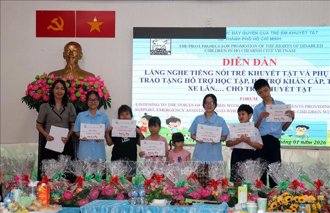 Đại diện địa phương trao tặng gói hỗ trợ chăm sóc sức khỏe cho trẻ khuyết tật tại diễn đàn. Ảnh: Thanh Vũ-TTXVN
