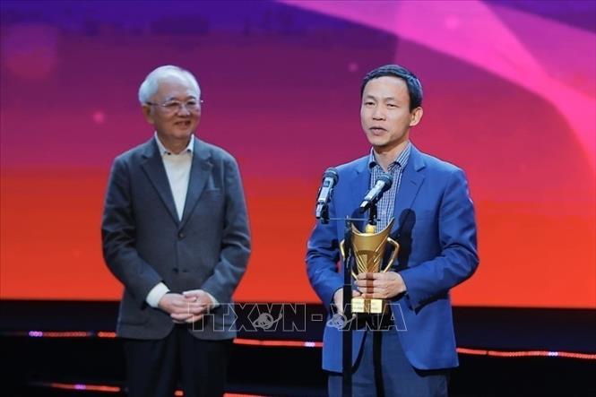 Giải thưởng Hình ảnh của năm là khoảnh khắc Nguyễn Đình Bắc trao chiếc mũ cối cho huấn luyện viên Kim Sang-sik do Liên đoàn bóng đá Việt Nam ghi lại. Ảnh: Minh Quyết - TTXVN
