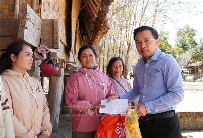 Giám đốc Sở Công Thương tỉnh Quảng Ngãi Nguyễn Thanh Mân tặng quà cho người dân. Ảnh: Cao Nguyên - TTXVN