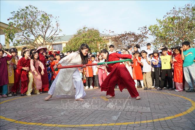 Học sinh trường Tiểu học Thu Thủy trải nghiệm các trò chơi dân gian truyền thống như nhảy bố, cầu kheo, đẩy gậy. Ảnh: Bích Huệ - TTXVN                                        