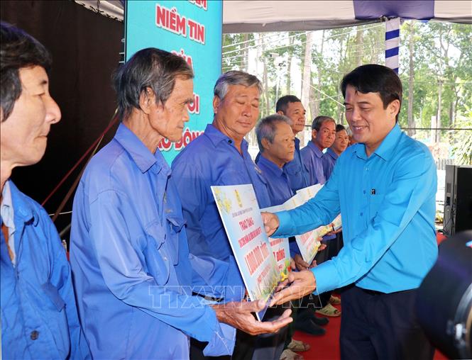 Chủ tịch Liên đoàn Lao động TP. Hồ Chí Minh Bùi Thanh Nhân trao tặng hỗ trợ công nhân lao động có hoàn cảnh khó khăn tại lễ khai mạc. Ảnh: Thanh Vũ-TTXVN