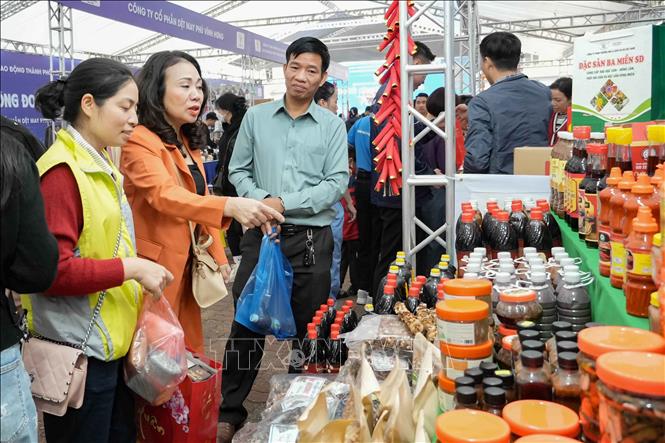 Người lao động chọn mua các mặt hàng nhu yếu phẩm, nông sản, thực phẩm thiết yếu phục vụ ngày Tết. Ảnh: Minh Nghĩa – TTXVN