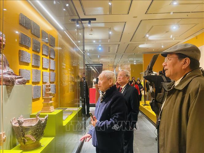 Các đại biểu tham quan các tư liệu, hiện vật tại trưng bày. Ảnh: Tuyết Mai - TTXVN