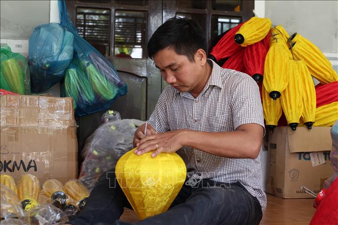 Anh Lê Vĩnh Hà (phường Điện Bàn, thành phố Đà Nẵng) đóng gói sản phẩm lồng đèn truyền thống cho nhà hàng, cơ sở, khách sạn tại Hội An. Ảnh: Khoa Chương - TTXVN