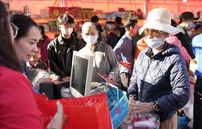 Người dân khó khăn được nhận quà Tết. Ảnh: Văn Dũng-TTXVN