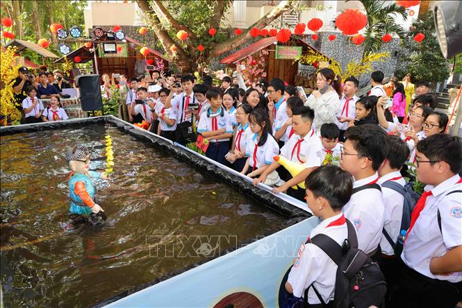 Biểu diễn múa rối nước phục vụ khách tham quan tại chương trình Sắc Xuân miệt vườn. Ảnh: TTXVN phát