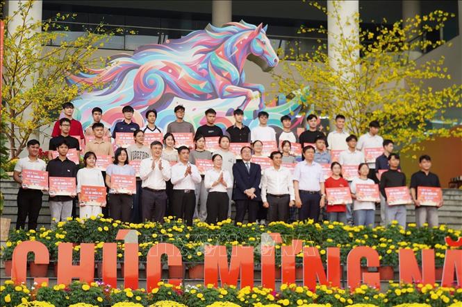 Ban tổ chức trao vé xe miễn phí đến các bạn sinh viên học tập tại Thành phố Hồ Chí Minh. Ảnh: Thu Hương - TTXVN