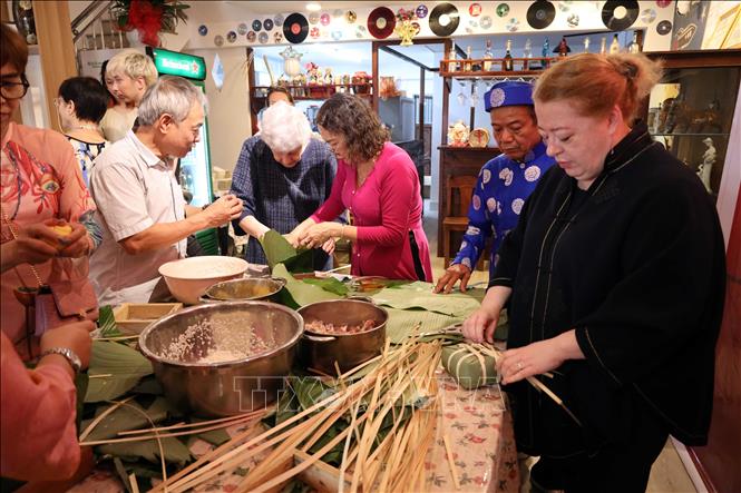 Vietnamese and Russian participants have hand-on experience of making banh Chung (a Vietnamese square-shaped sticky rice cake). VNA Photo: Trần Lê Lâm