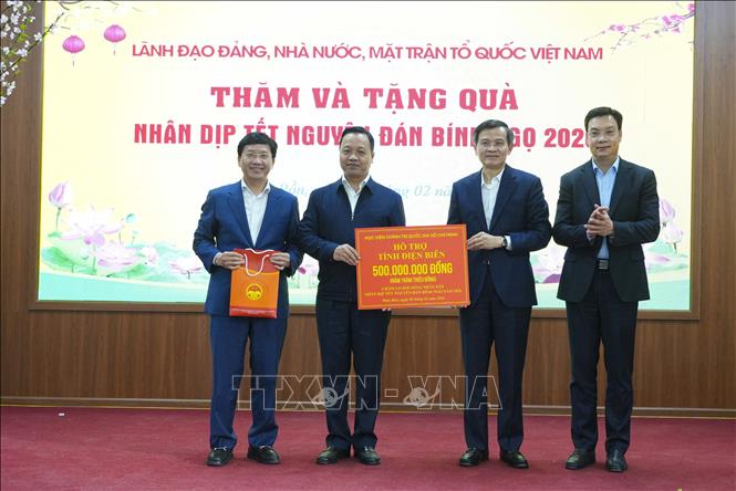 Giám đốc Học viện Chính trị quốc gia Hồ Chí Minh Đoàn Minh Huấn trao tượng trưng số tiền hỗ trợ tỉnh Điện Biên chăm lo Tết cho người nghèo. Ảnh: Xuân Tư - TTXVN