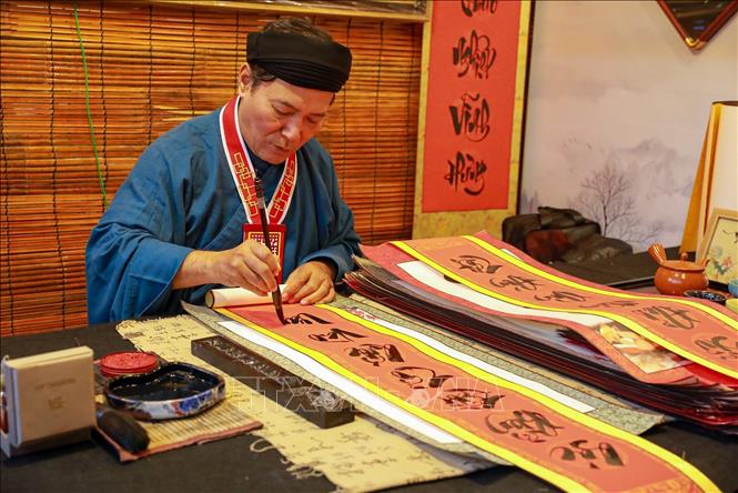 Ông đồ viết chữ thư pháp tại Hội chữ Xuân Bính Ngọ. Ảnh: Khánh Hoà - TTXVN