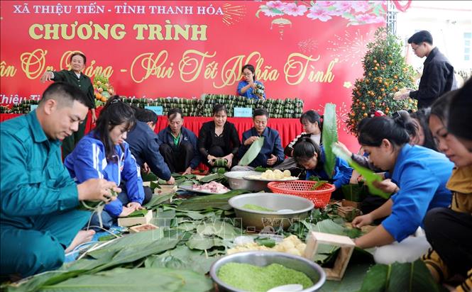 Cán bộ, đảng viên cùng với dân gói bánh chưng, chuyện trò, thắt chặt thêm sự gắn bó giữa chính quyền và nhân dân. Ảnh: Việt Hoàng - TTXVN 