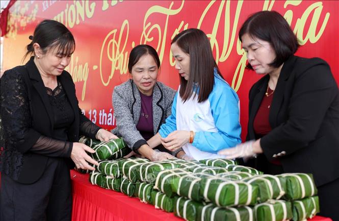 Bánh chưng được gói theo đúng phong tục truyền thống, mang đến cho người nghèo và các đối tượng yếu thế một cái Tết ấm cúng, đậm đà tình nghĩa. Ảnh: Việt Hoàng - TTXVN 