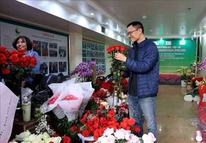 A man picks out red roses for his partner on Valentine's Day. VNA Photo