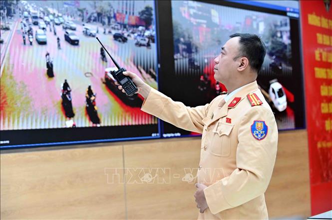 Trung tá Nguyễn Văn Khương, Phó Đội trưởng Đội Chỉ huy giao thông và Điều khiển đèn tín hiệu giao thông trực tiếp chỉ huy, phân luồng, điều tiết giao thông và cảnh báo sớm các điểm ùn tắc qua hệ thống Camera AI. Ảnh: Phạm Kiên - TTXVN