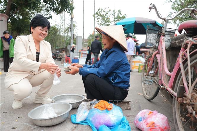Phiên chợ mùng 2 Tết cũng là cơ hội để mọi người có thời gian mua sắm cho dịp Tết và cũng để cầu cho một năm buôn bán thuận lợi. Ảnh: Minh Quyết - TTXVN