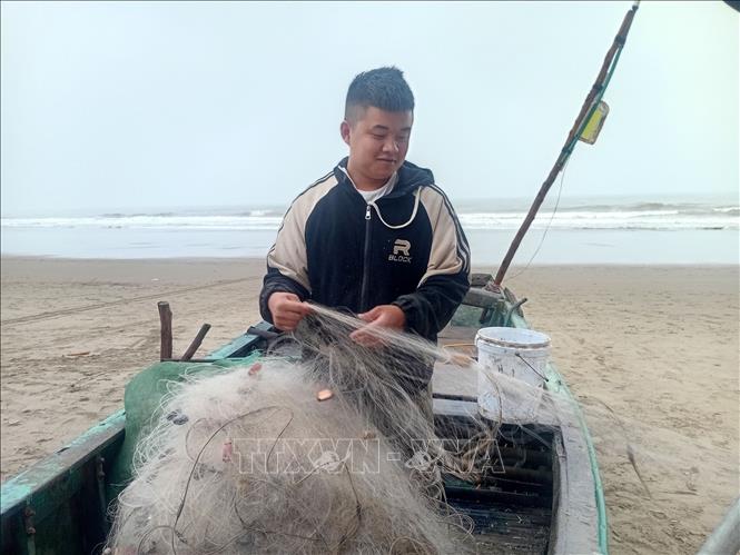 Anh Văn Đình Hòa, phường Sầm Sơn, Thanh Hóa đang chuẩn bị lưới cá để ra khơi trong chiều 19/2. Ảnh: Nguyễn Nam-TTXVN