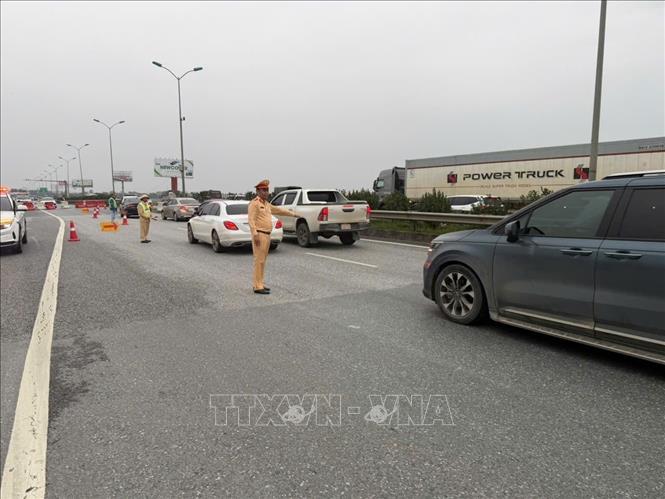 Đội CSGT đường bộ cao tốc số 3 (Cục CSGT) tổ chức phân luồng cho các phương tiện đi ngược chiều (theo hướng dẫn của lực lượng CSGT) từ Km216 đến Km211 nhằm tạo điều kiện cho phương tiện lưu thông thuận lợi về Hà Nội. Ảnh: TTXVN