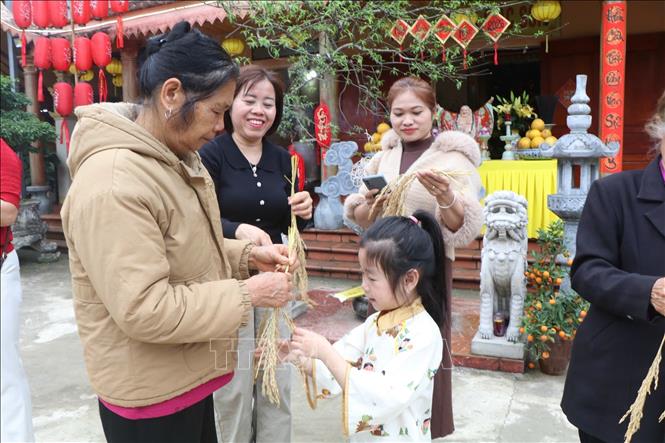 Người dân phấn khởi nhận lộc trong Tết Doi. Ảnh: Nguyễn Thảo - TTXVN