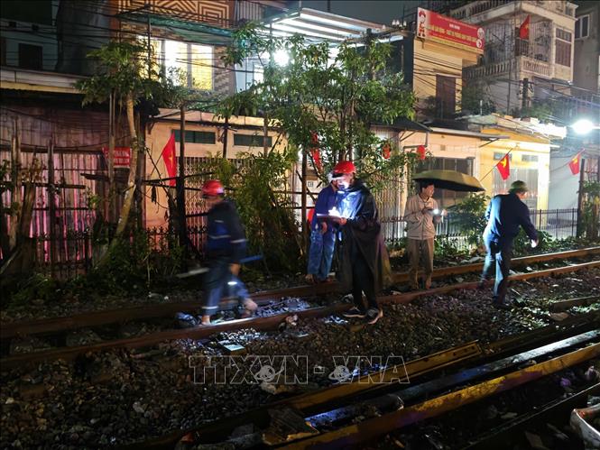 Công nhân đường sắt khẩn trương tiến hành sửa chữa lại vị trí đường ray bị hư hỏng sau vụ va chạm. Ảnh: Trung Nguyên - TTXVN