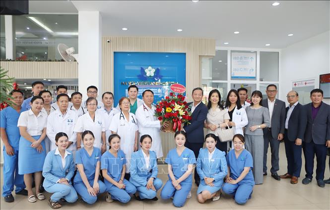 Đại sứ Việt Nam tại Lào Nguyễn Minh Tâm tặng hoa chúc mừng tập thể cán bộ y, bác sĩ Bệnh viện nhân Ngày Thầy thuốc Việt Nam. Ảnh: Xuân Tú - PV TTXVN tại Lào