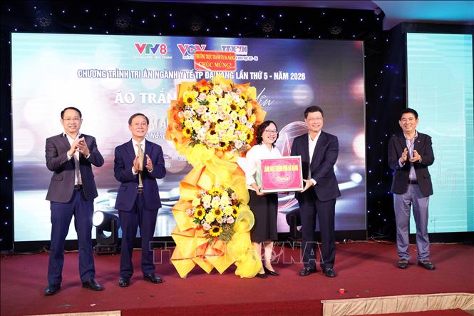 Ông Ngô Xuân Thắng, Phó Bí thư Thành ủy Đà Nẵng thay mặt lãnh đạo thành phố trao hoa chúc mừng đại diện ngành y tế và các đơn vị tổ chức. Ảnh: Trần Lê Lâm - TTXVN