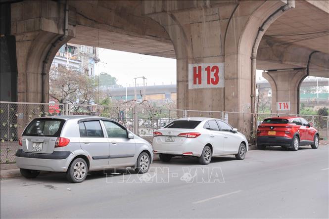 Lòng đường dưới gầm cầu Vĩnh Tuy, xe đỗ sát nhau, tiềm ẩn nhiều nguy cơ tai nạn giao thông và cháy nổ. Ảnh: Phan Phương – TTXVN