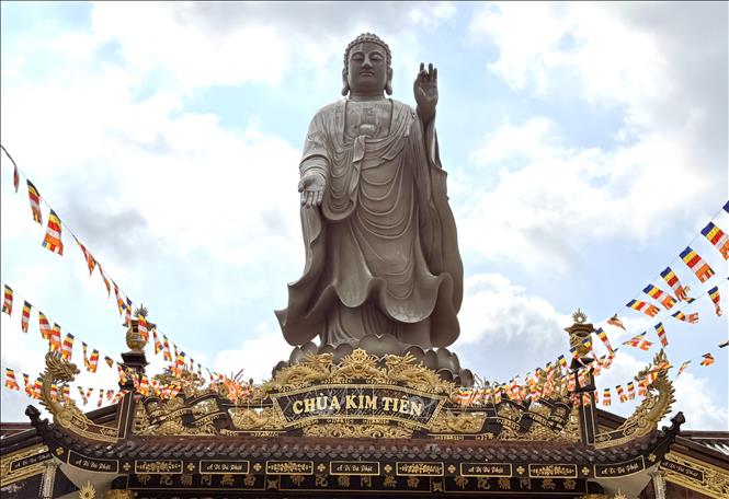 The 24-metre Amitabha Buddha statue stands majestically on the roof of the main hall at Kim Tien Pagoda. Photo: Thanh Sang – VNA 