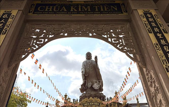 The 24-metre Amitabha Buddha statue atop the main hall, seen from the pagoda’s triple-arched gate. Photo: Thanh Sang – VNA 