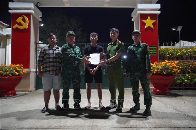 Lực lượng chức năng Đồn Biên phòng cửa khẩu Mỹ Quý Tây tiếp nhận đối tượng Lê Anh Tuấn. Ảnh: TTXVN phát