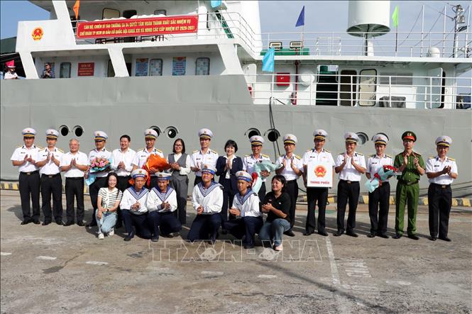 Thành viên Ủy ban Bầu cử xã Long Sơn (Thành phố Hồ Chí Minh) và Thủ trưởng Vùng 2 Hải quân tặng hoa chúc mừng Tổ bầu cử sớm trên biển. Ảnh: Đoàn Mạnh Dương-TTXVN