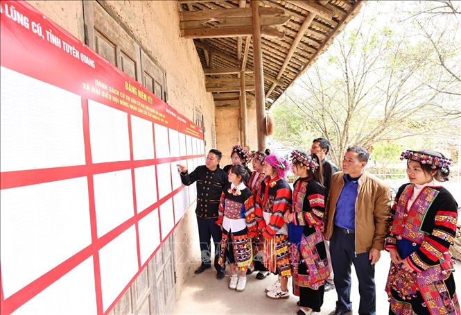 Cử tri xem danh sách đại biểu ứng cử được niêm yết công khai tại nhà văn hóa thôn Lô Lô Chải, xã Lũng Cú. Ảnh: Minh Đức – TTXVN