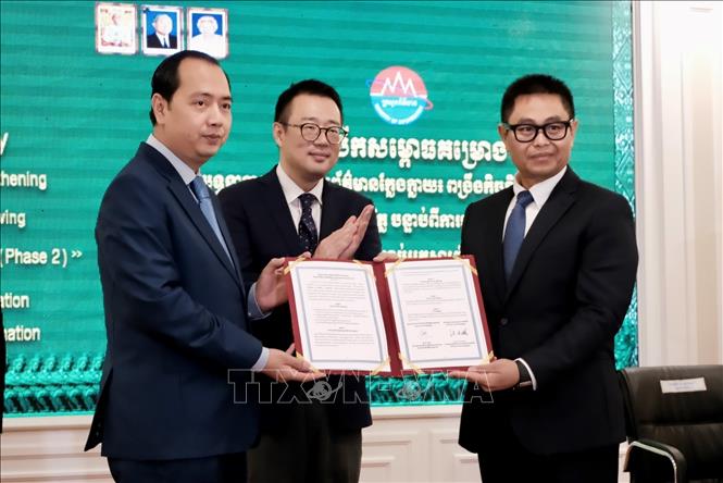 Ông Neth Pheaktra, Bộ trưởng Bộ Thông tin Campuchia (trái) trao văn bản về chiến dịch chống tin giả cho Phó Quốc vụ khanh Bộ Thông tin Prak Thaveak Amida phụ trách triển khai thực hiện. Ảnh: Quang Anh – PV TTXVN tại Campuchia