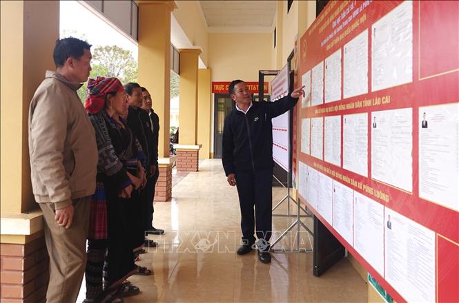 Cán bộ xã Púng Luông giới thiệu tới cử tri danh sách, tiểu sử các ứng cử viên đại biểu Quốc hội và Hội đồng Nhân dân các cấp. Ảnh: Tuấn Anh - TTXVN